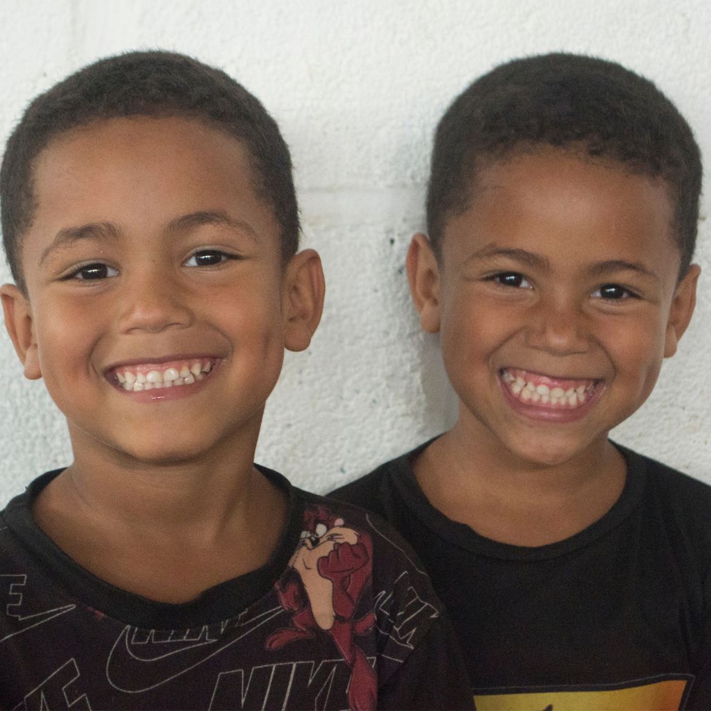 dos niños con camiseta negra sonriendo