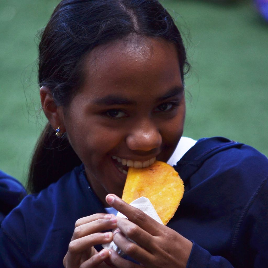 niña comiendo empanada